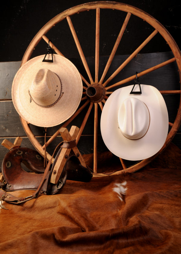 Hat hanger with hats on wagon wheel